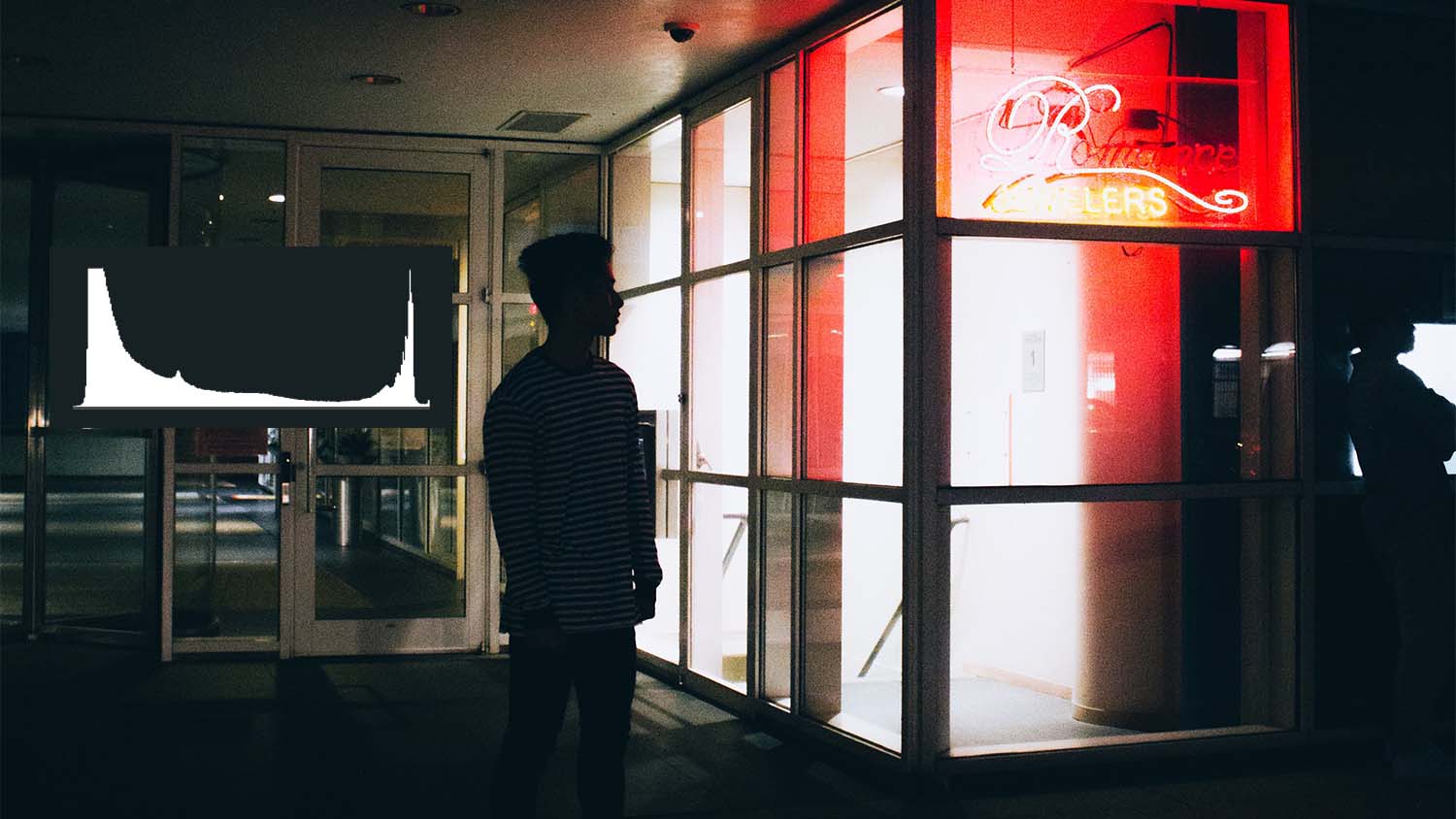 person standing at night with histogram