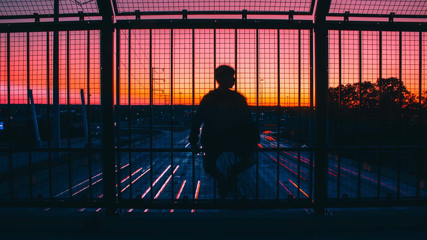person sitting over busy highway