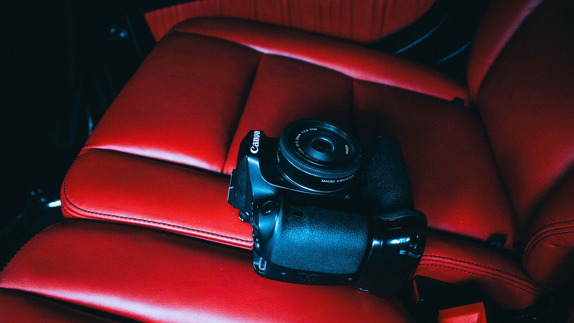 Black canon camera contrasting radiant red interior.
