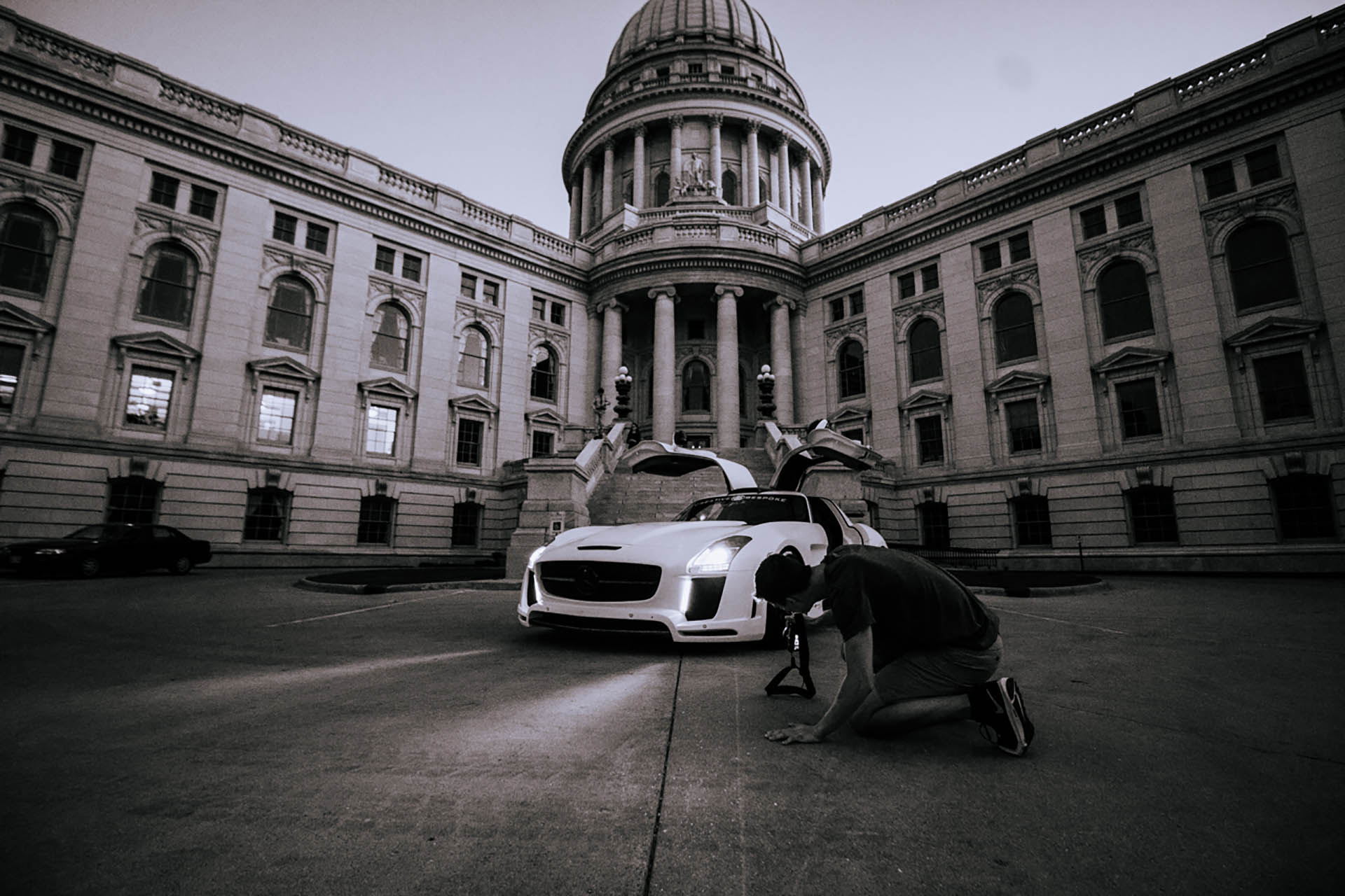 Monochromatic image of a white Mercedes Benz, in front of the Madison Capitol Building.