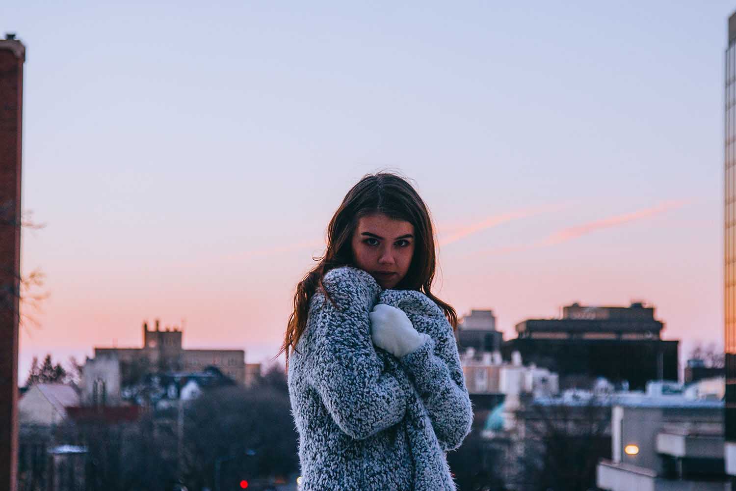 Girl in teddy grey coat model poses during winter for photoshoot